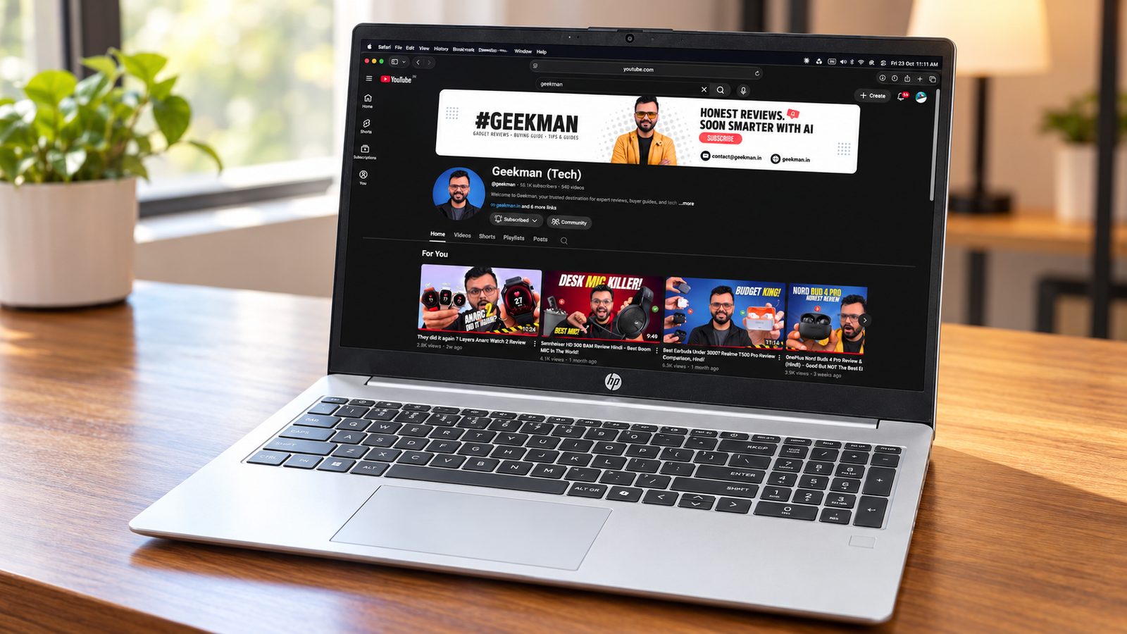 HP 15 Ryzen 5 7335U laptop with Geekman YouTube channel banner on screen