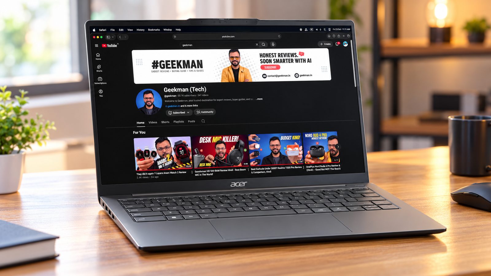 Acer Swift Neo laptop on a wooden desk with the Geekman channel on screen