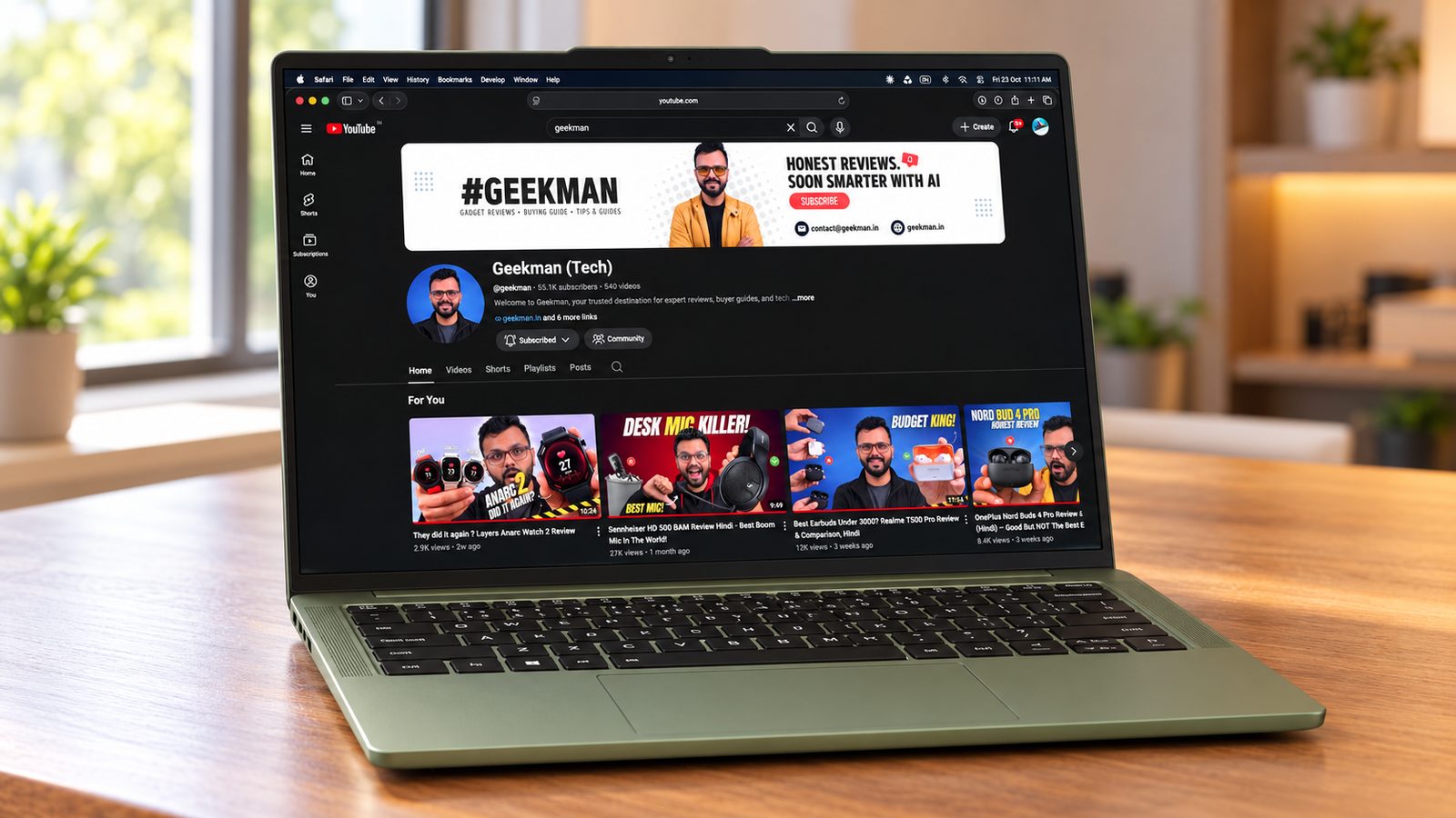 Motorola Moto Book 60 OLED laptop on a wooden desk with the Geekman channel on screen
